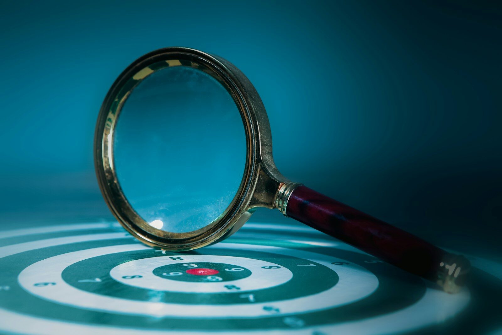 Magnifying glass over a target with bullseye